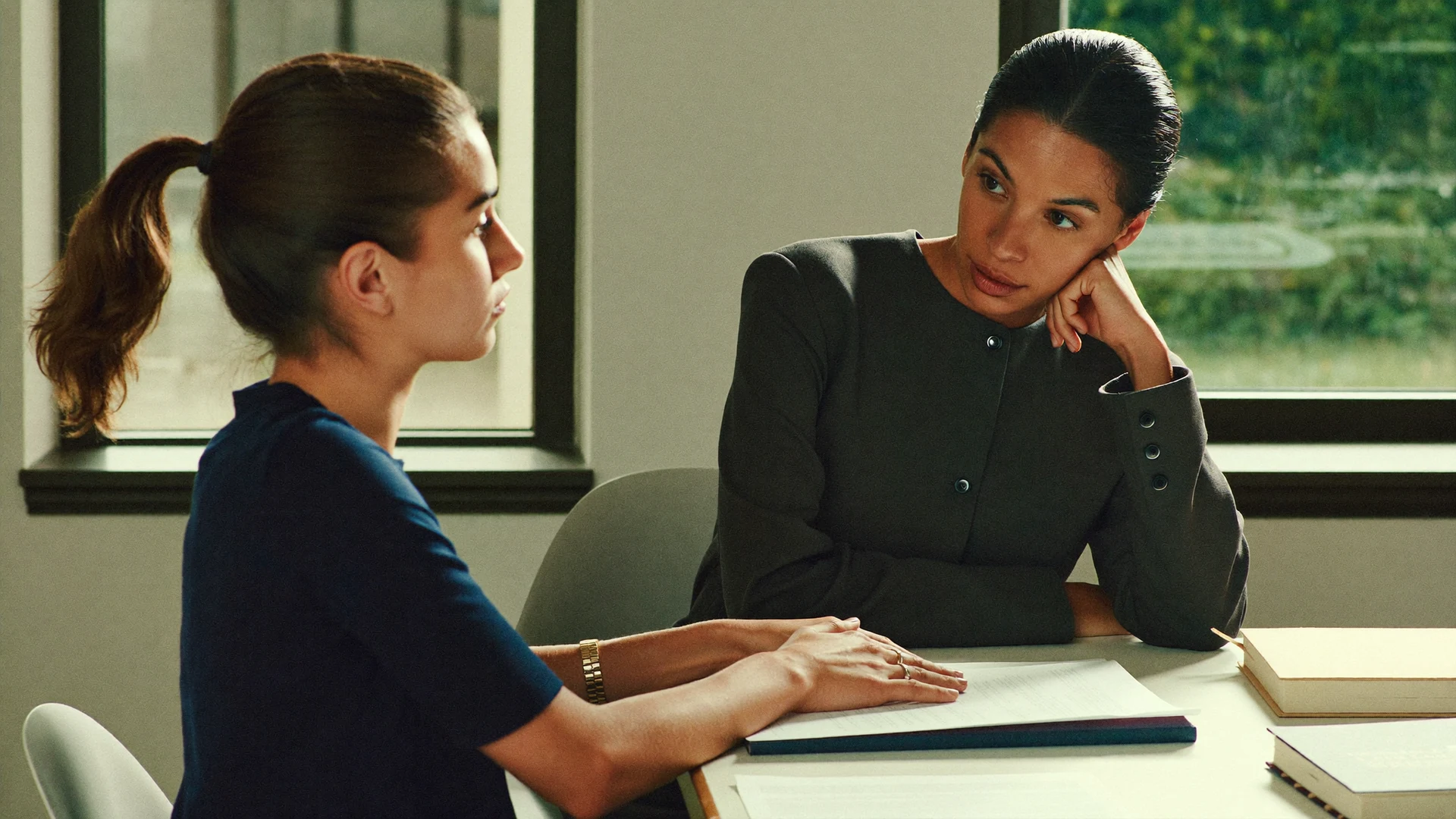 Illustrative mentor listening attentively to a young adult across a table